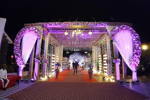 Kasturi Bagh Jaipur grand wedding entrance decorated with flowers and lighting at night — luxury wedding destination
