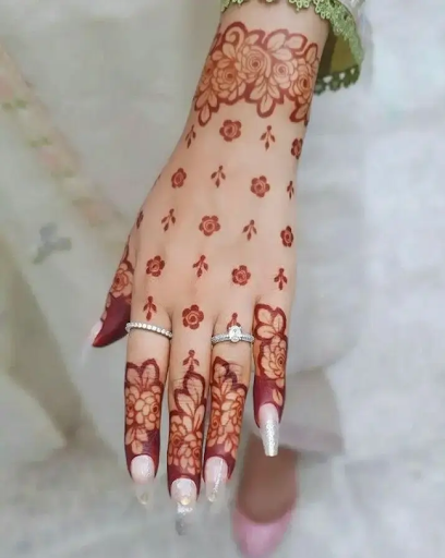 Floral back hand minimal mehndi with elegant finger details