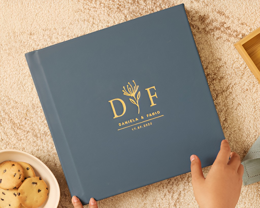 Elegant wedding album cover with gold foil initials and floral design